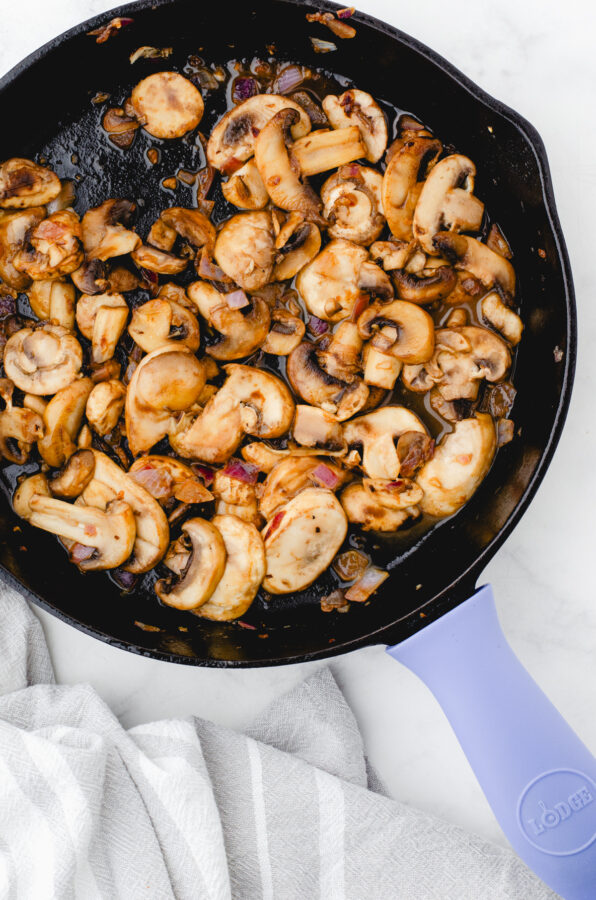 Sauted mushrooms, garlic, and onions in a cast iron pan