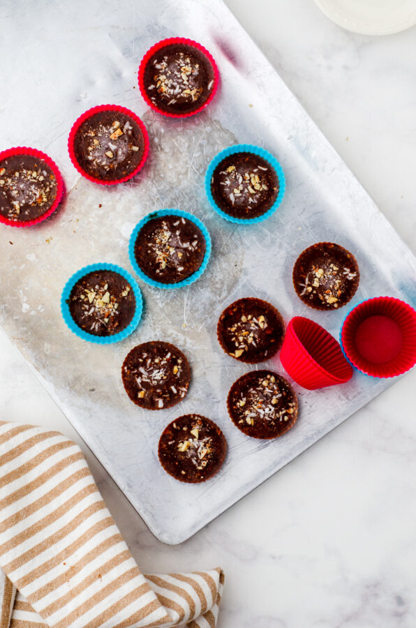 Chilled almond butter chocolate cups - some having been popped out of their silicone cups.