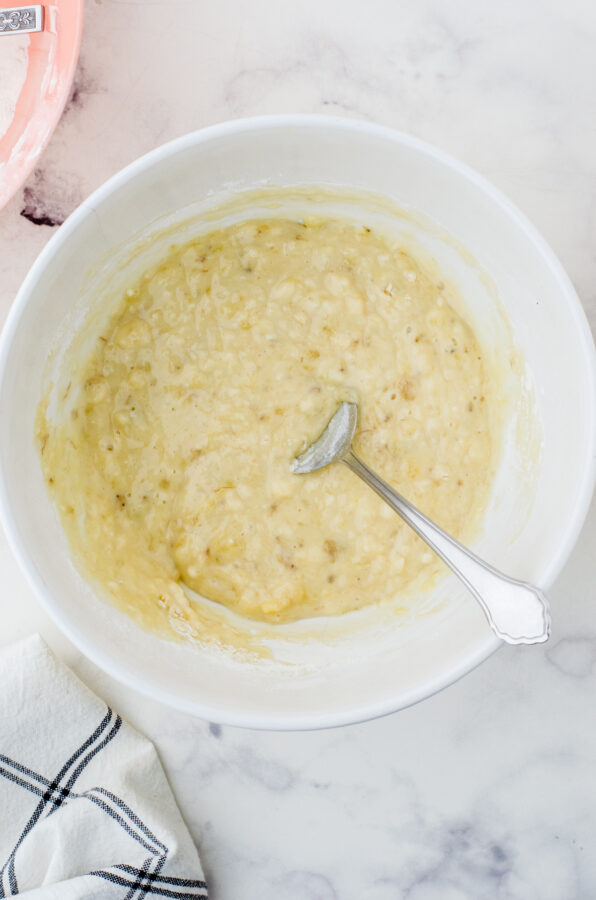 Banana cake batter stirred together in a mixing bowl.