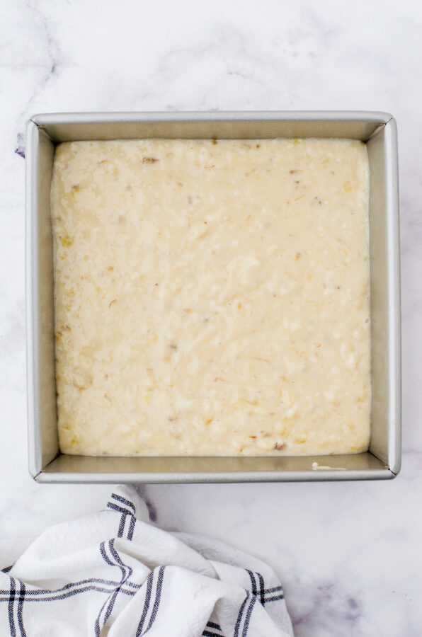 Banana cake batter poured into an 8x8 inch pan.