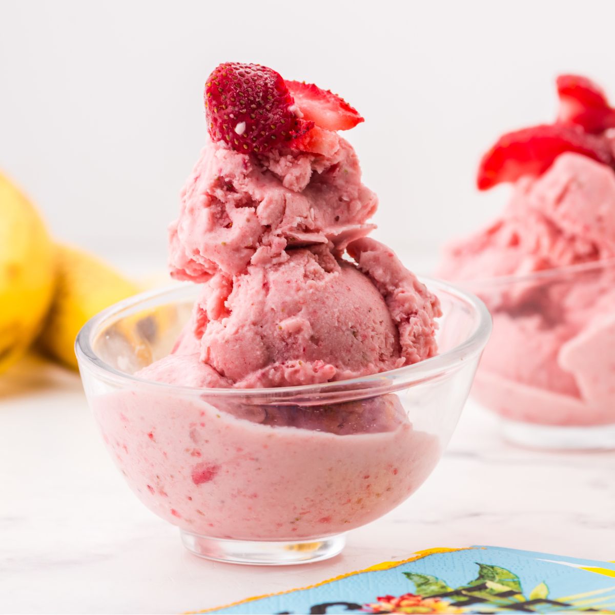 bowl of frozen yogurt with a strawberry on top