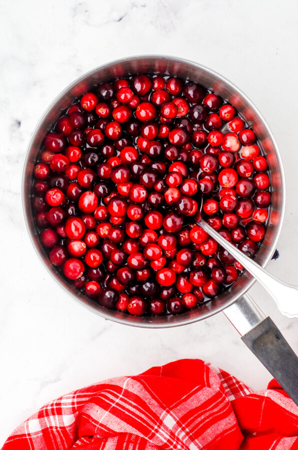 Cranberries in a saucepan with sugar water