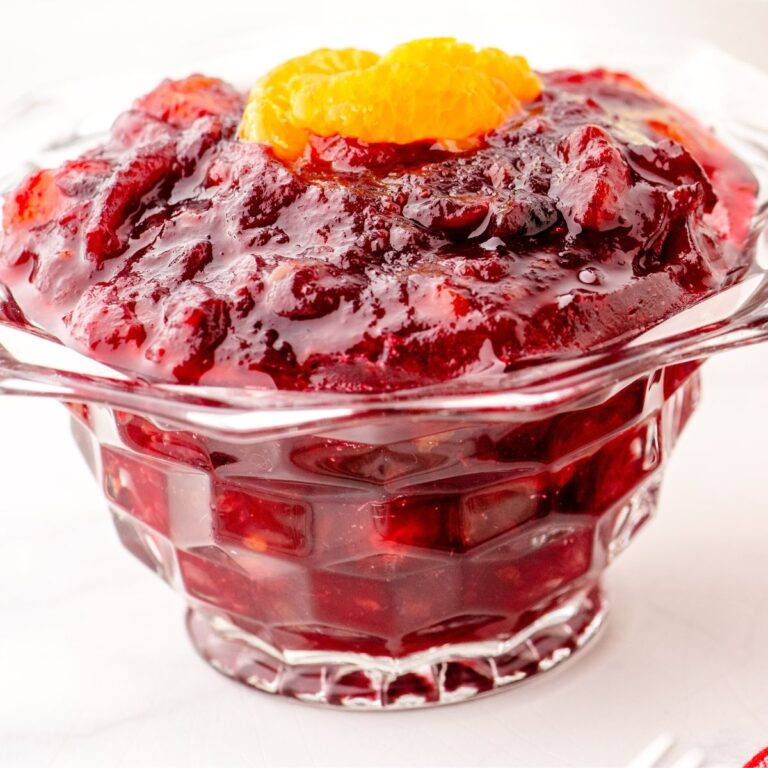 a bowl of homemade cranberry sauce with a few slices of mandarin oranges on the top