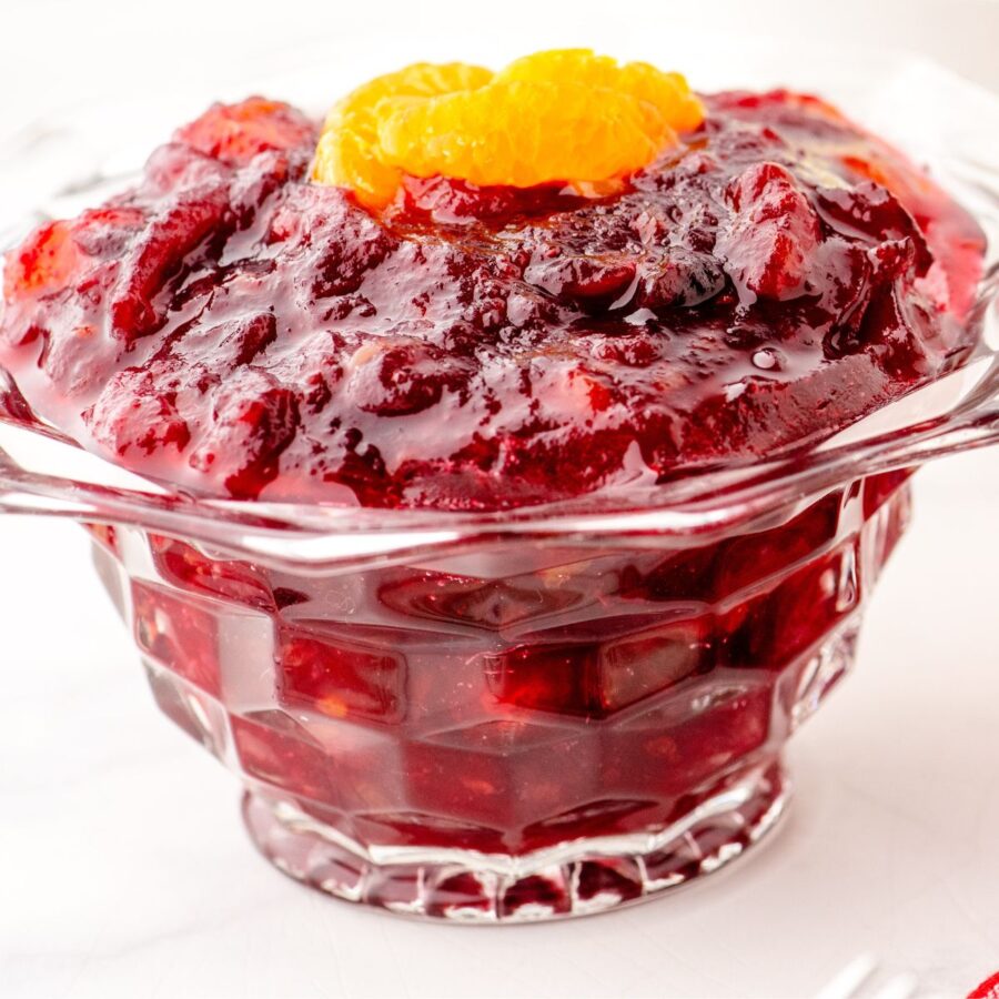 a bowl of homemade cranberry sauce with a few slices of mandarin oranges on the top