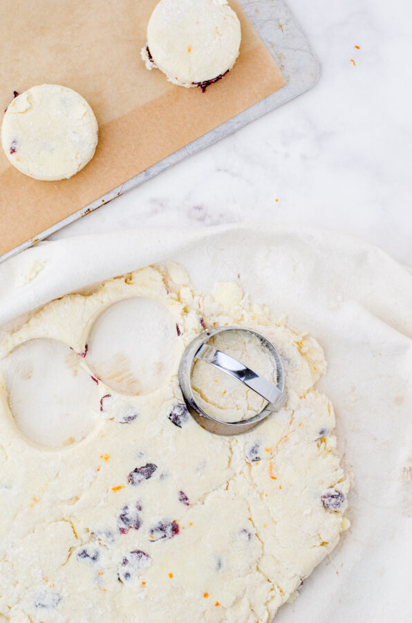 Cream scones being cut with a round cutter