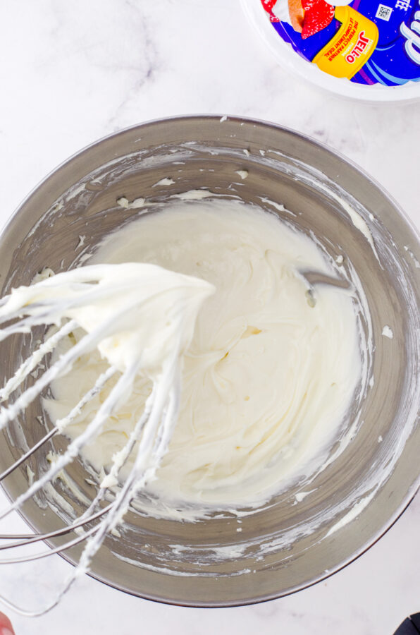 Cream cheese & sugar whipped together in a stand mixer bowl.