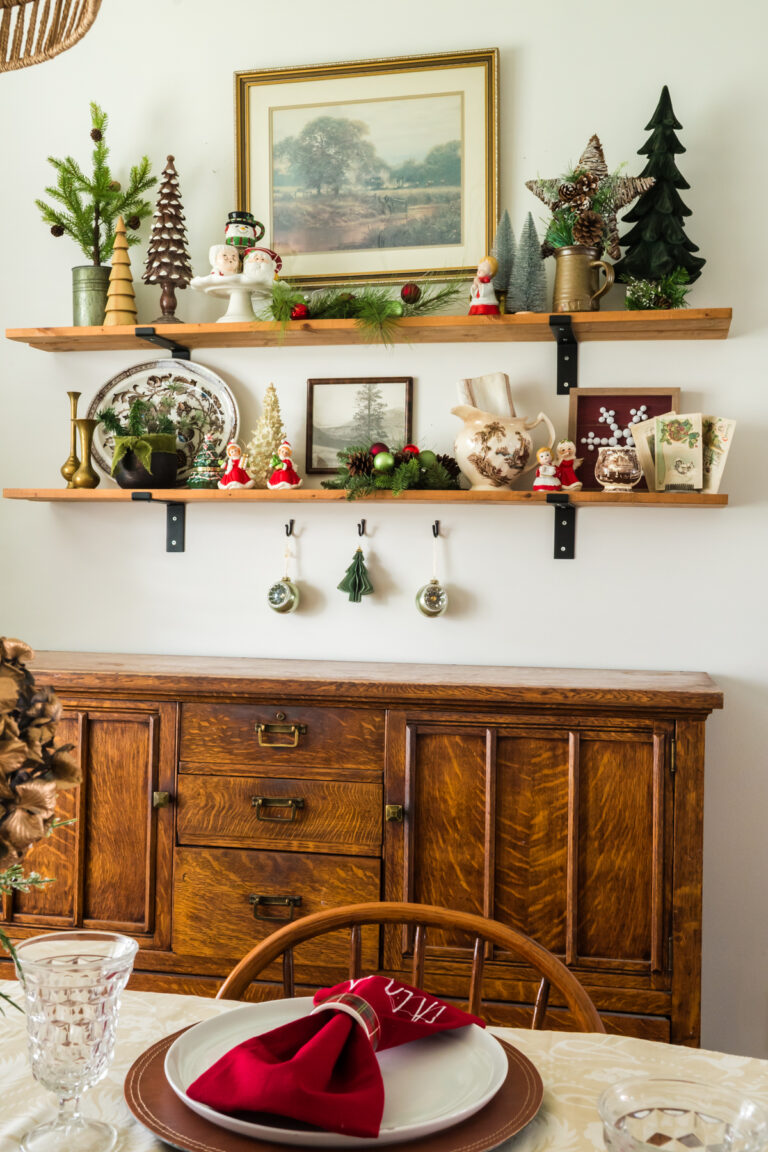 Shelves above an antique buffet styled with Christmas decor