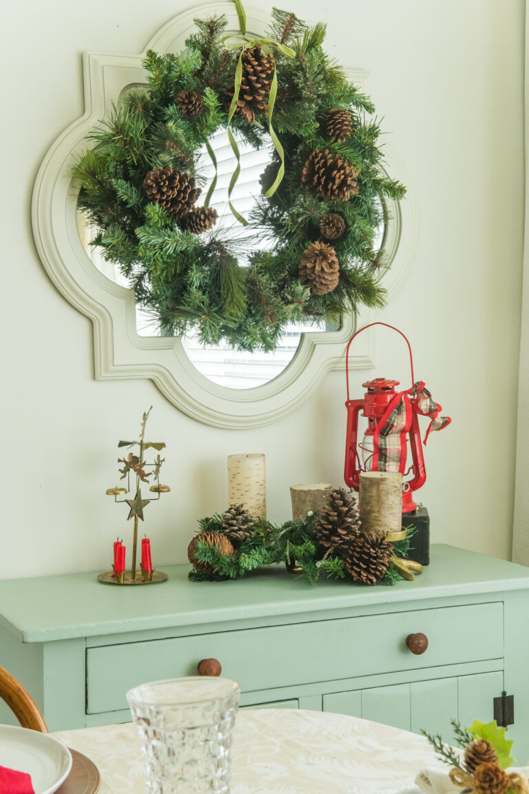 A small antique dresser styled with a Christmas vinette