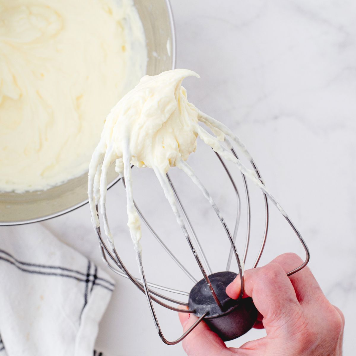 a mixer beater with vanilla pudding mix frosting on it
